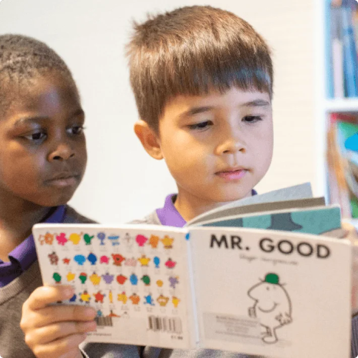two students reading a book