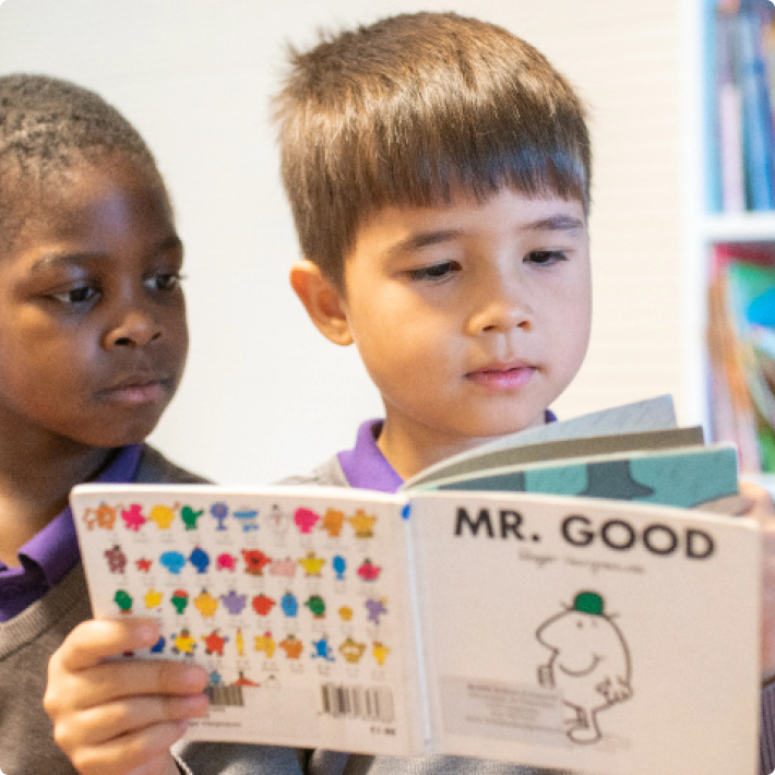 two students reading a book