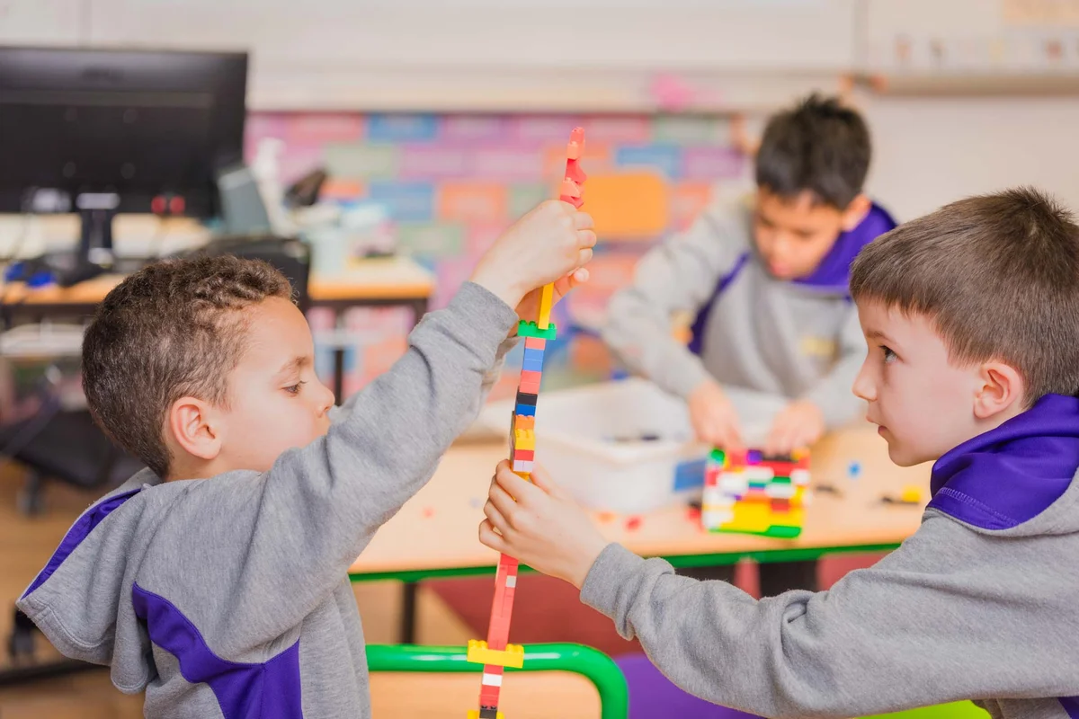 two students playing in the classroom