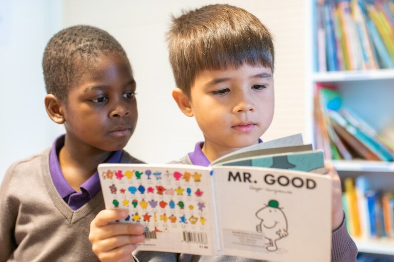 two students reading a book