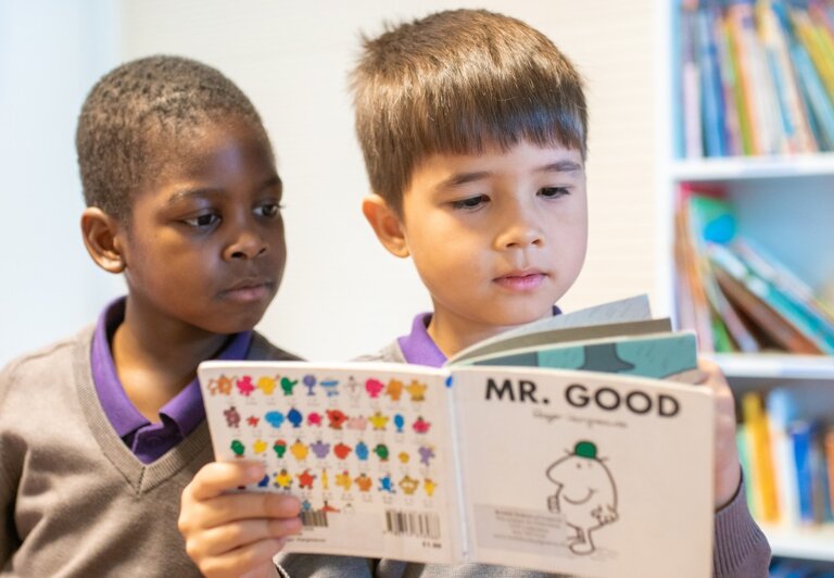 two students reading a book