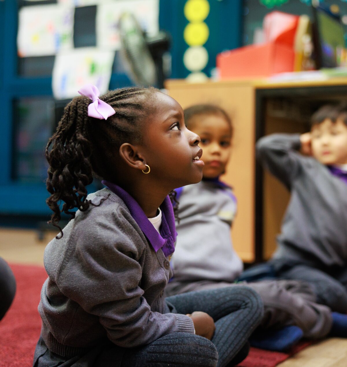 students sitting on the floor in the classroom