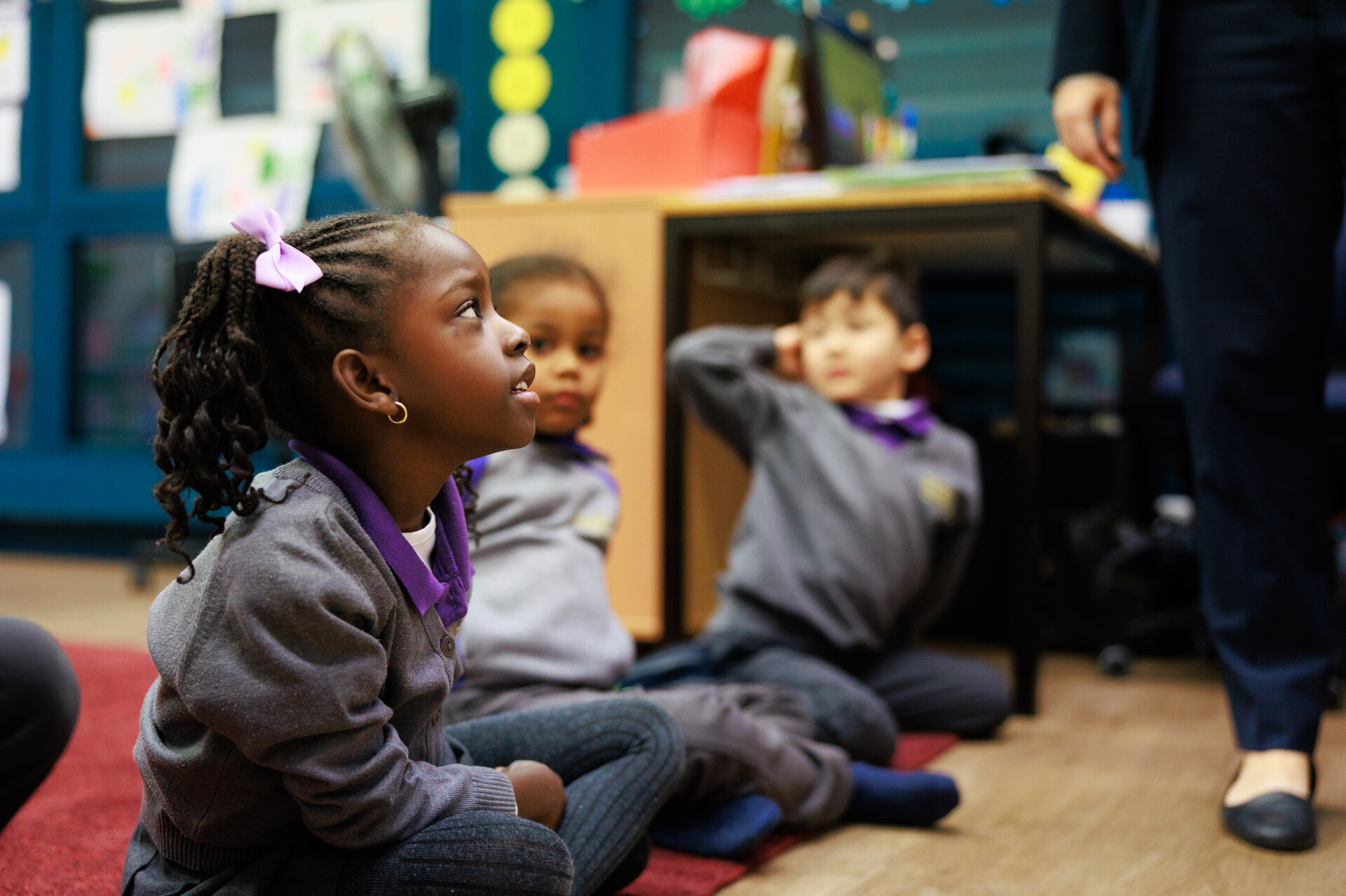 students sitting on the floor in the classroom
