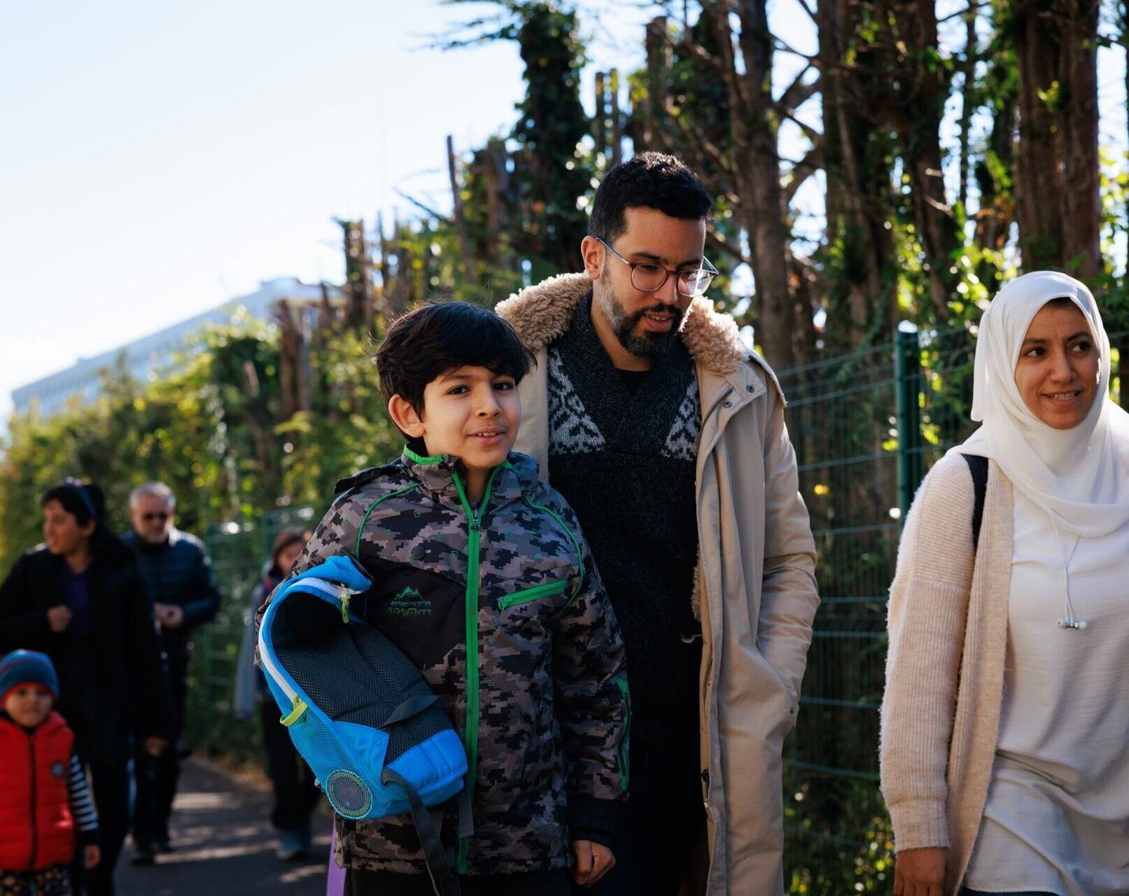 parents and student in the schoolyard
