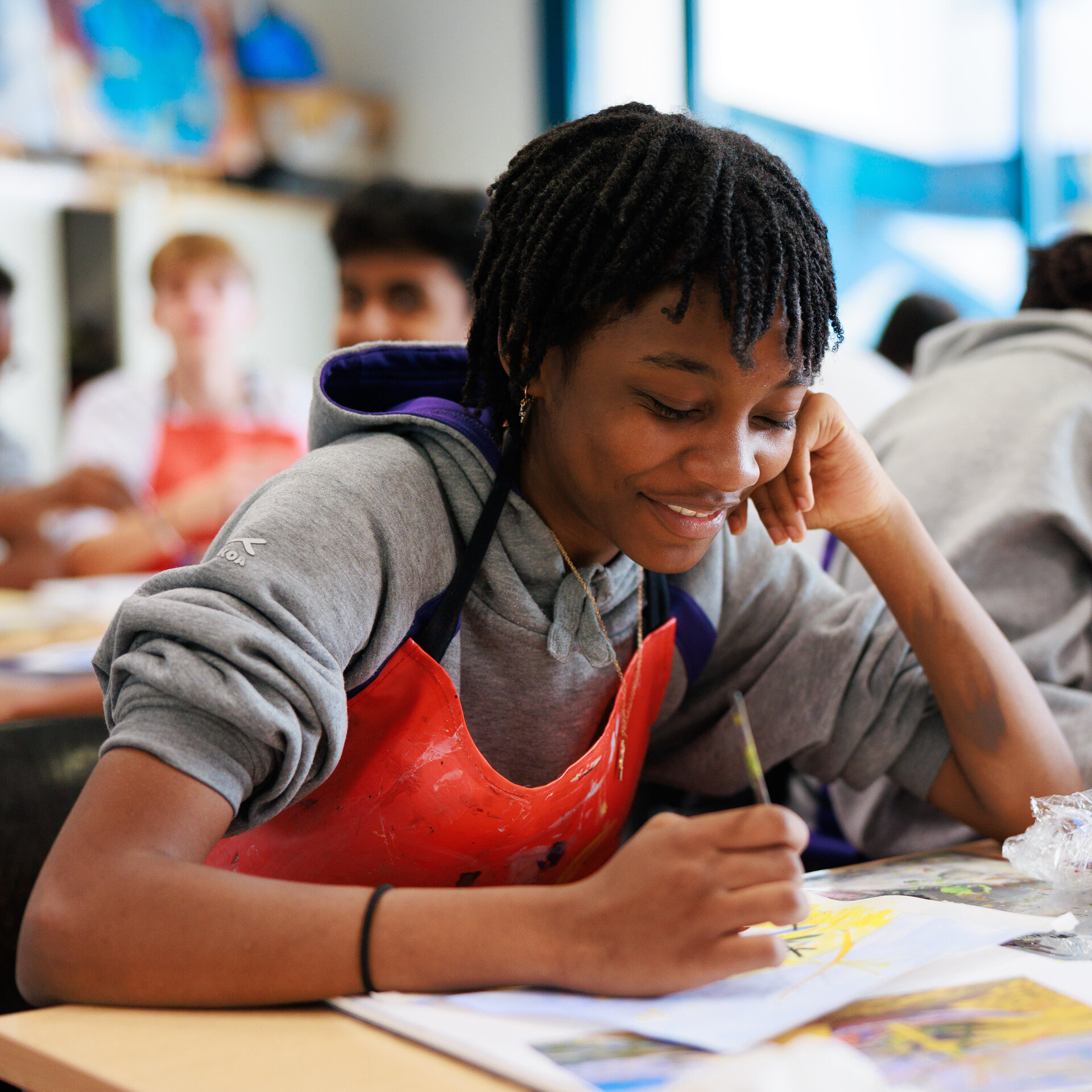 student smiling and painting
