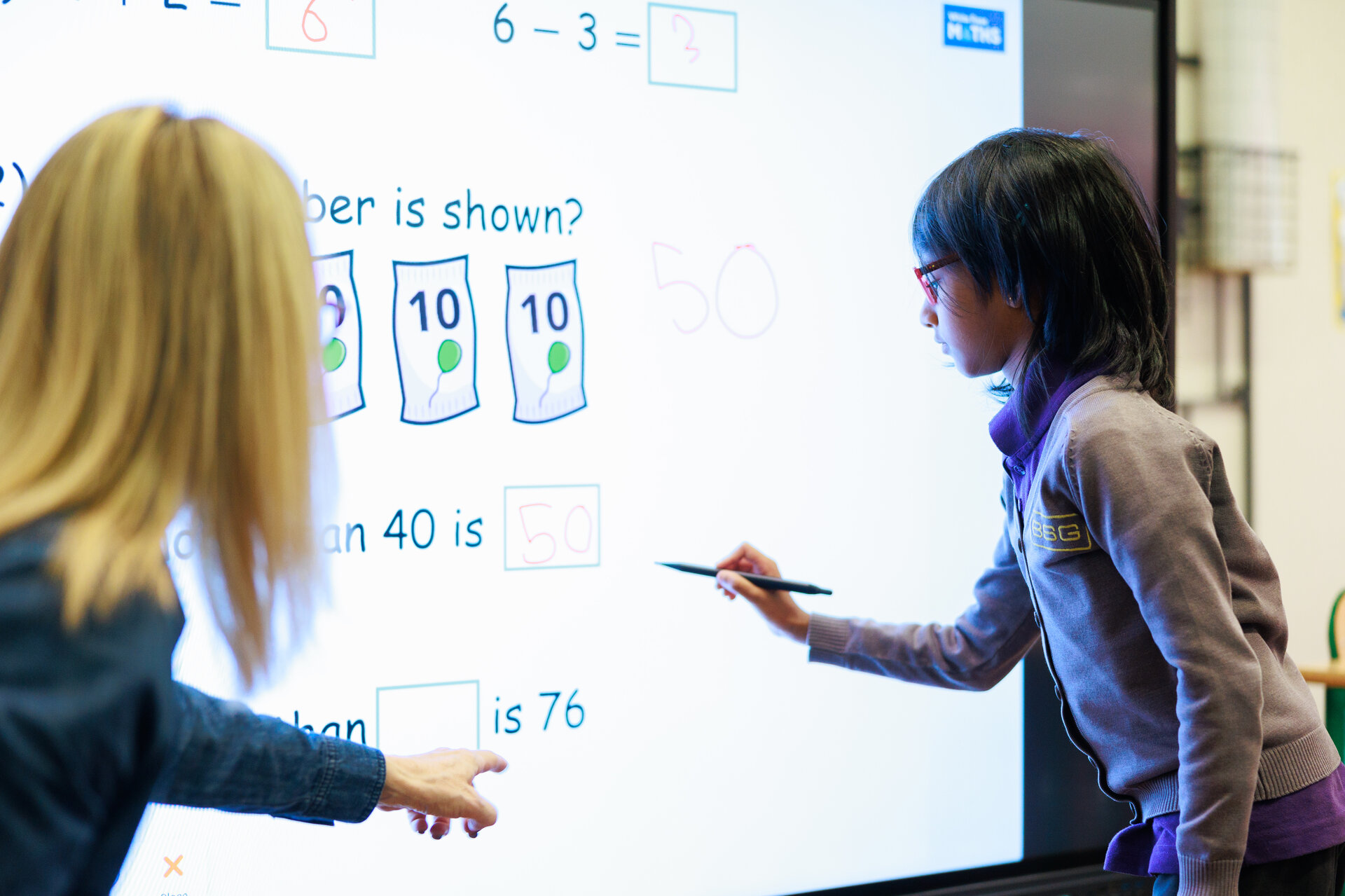 student writing on a whiteboard