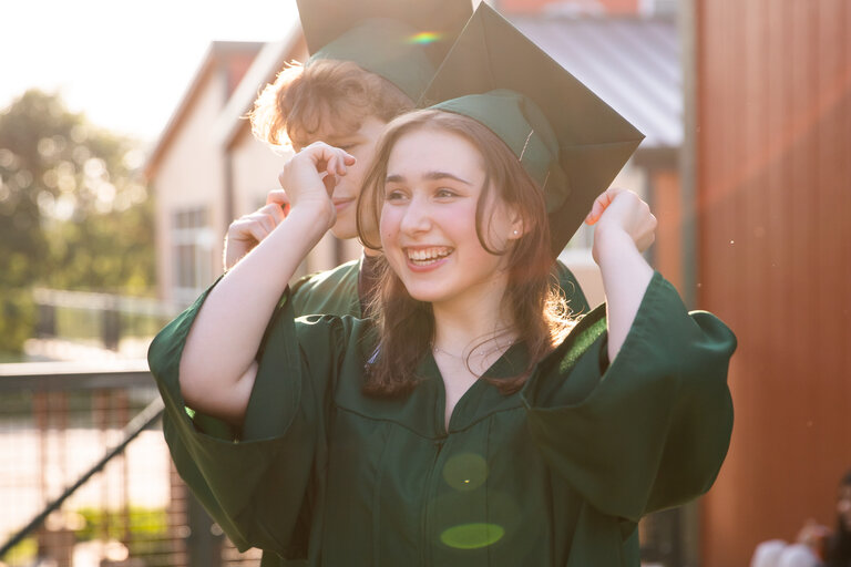 Girls smiling while wearing graduation dress